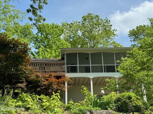 view of side of property with a sunroom