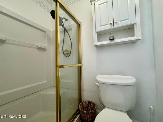 bathroom with a shower with shower door and toilet