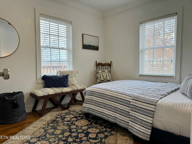 bedroom with crown molding, multiple windows, and dark hardwood / wood-style flooring