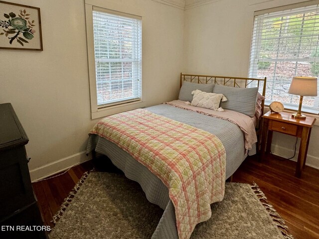 bedroom with dark wood-type flooring