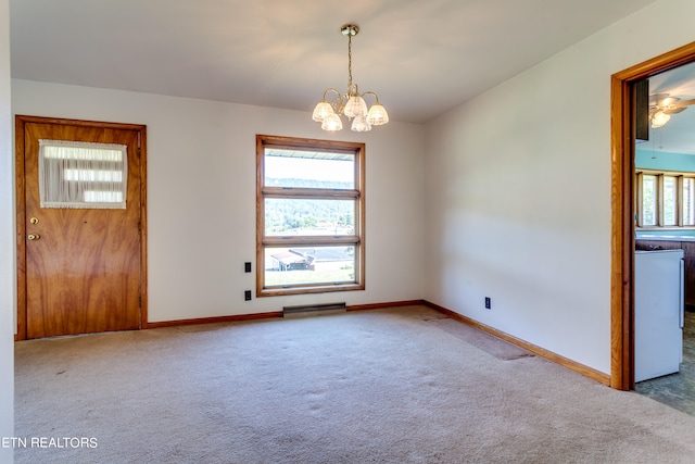 empty room with light carpet, a baseboard radiator, and a notable chandelier