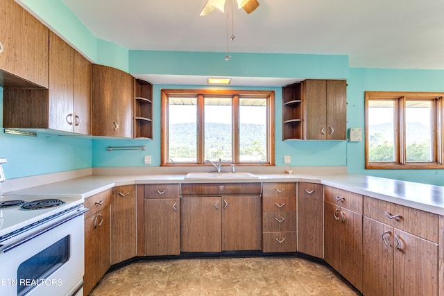 kitchen with ceiling fan, sink, and white electric range oven