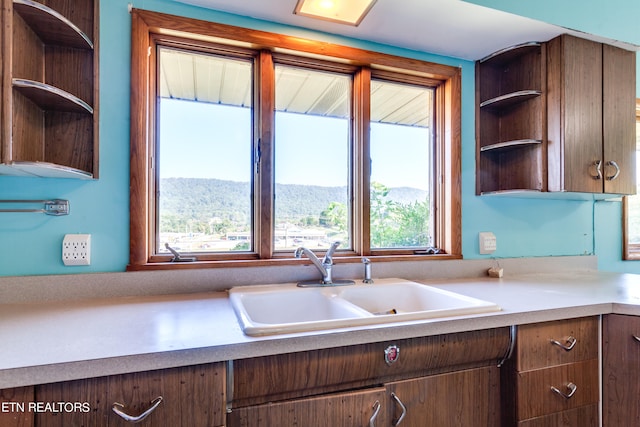 kitchen with a mountain view and sink