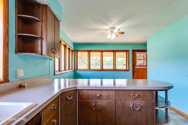 kitchen with ceiling fan, sink, and kitchen peninsula