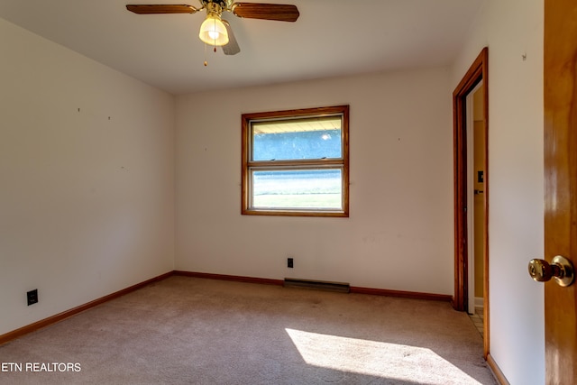 carpeted spare room with ceiling fan