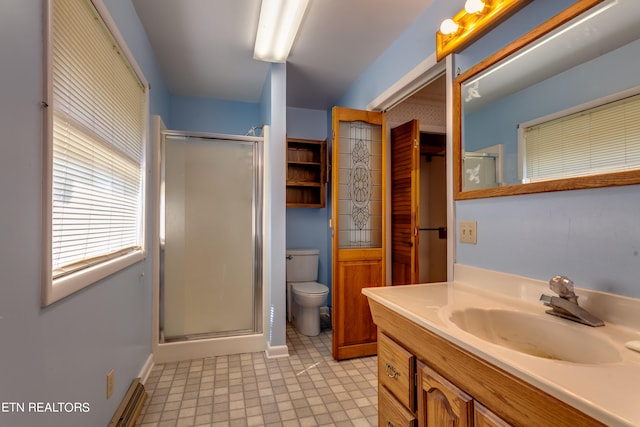 bathroom featuring vanity, toilet, and walk in shower