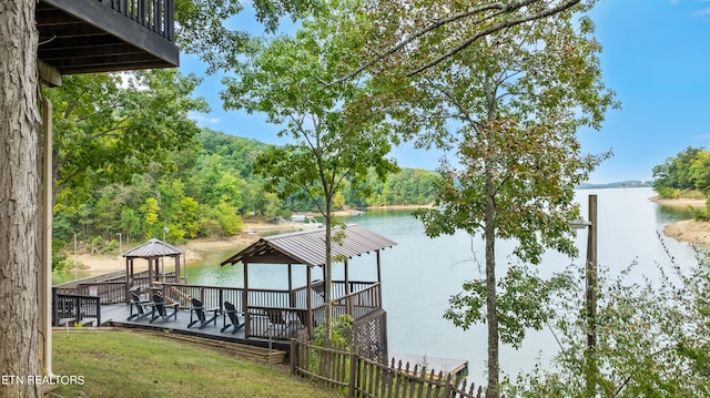 view of dock featuring a deck with water view and a gazebo