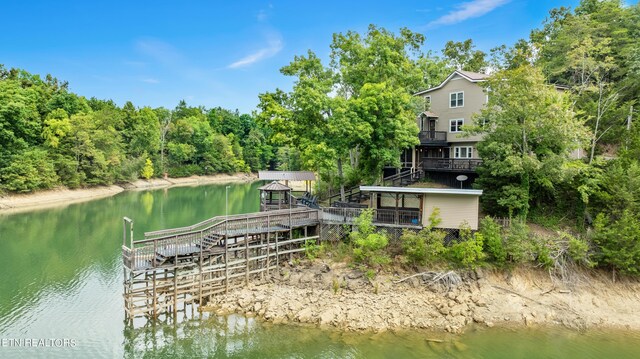 view of dock with a deck with water view