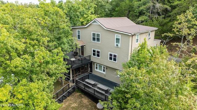 bird's eye view with a wooded view