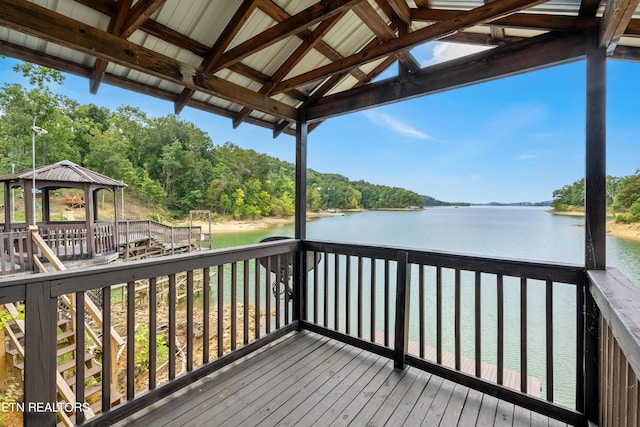 wooden deck with a water view and a gazebo