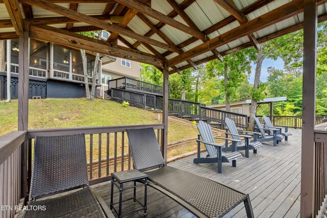 wooden deck featuring a lawn