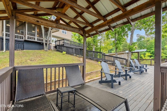 wooden deck featuring a lawn and fence