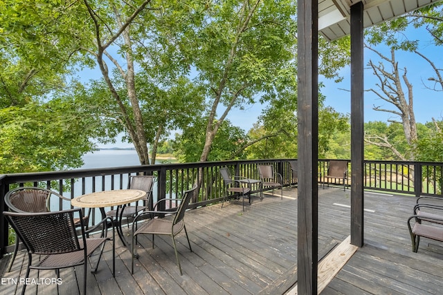 wooden terrace featuring a water view