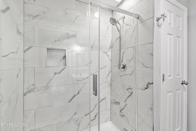 bathroom with a shower with shower door