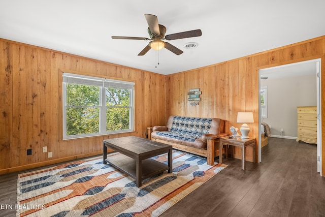living room with baseboards, visible vents, ceiling fan, and wood finished floors