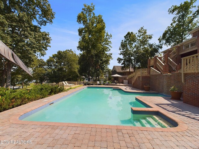 view of pool with a patio and a jacuzzi