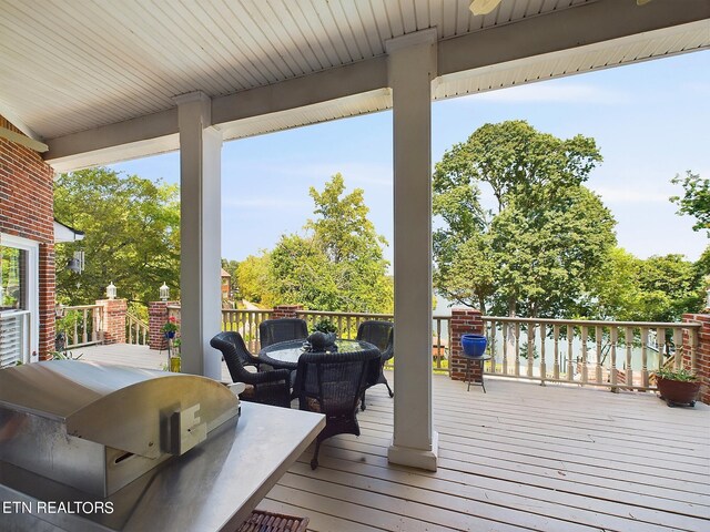 wooden terrace featuring a grill