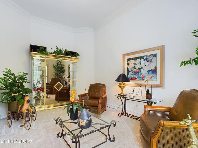 sitting room featuring ornamental molding and light colored carpet