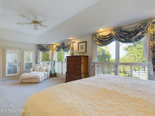 carpeted bedroom with ceiling fan, multiple windows, and access to exterior