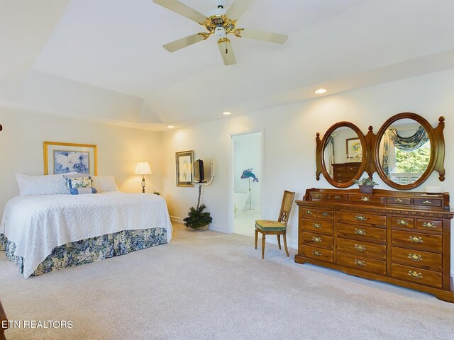 carpeted bedroom featuring ensuite bath and ceiling fan