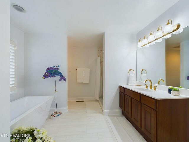 bathroom featuring vanity, tile patterned flooring, and plus walk in shower