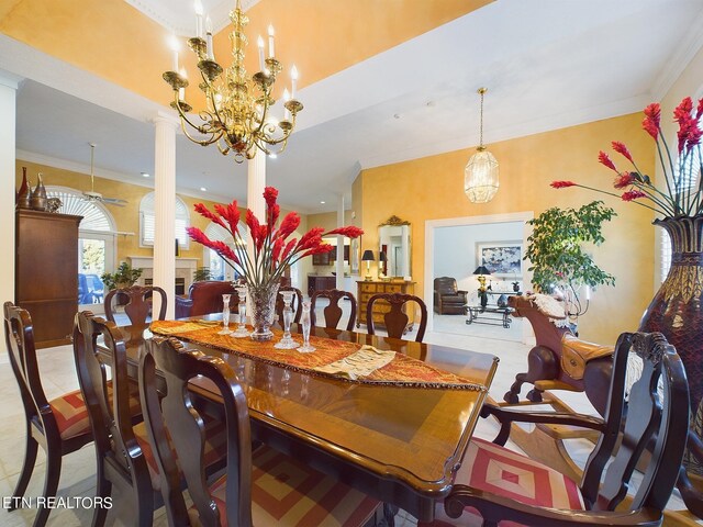 tiled dining space with ornate columns, ornamental molding, and ceiling fan with notable chandelier