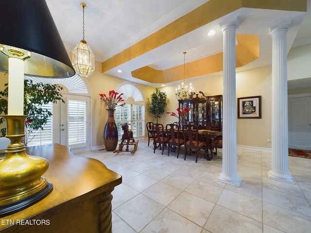 dining room with crown molding, ornate columns, an inviting chandelier, and light tile patterned floors