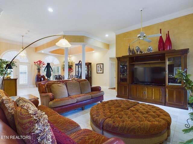 living room with crown molding, ornate columns, light tile patterned floors, and ceiling fan