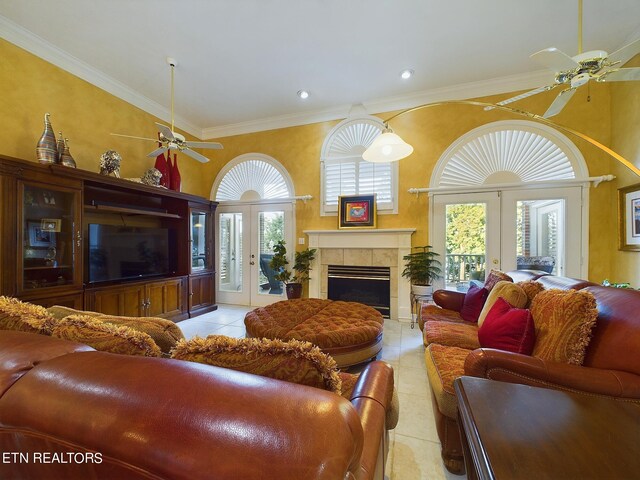 tiled living room with french doors, ceiling fan, a healthy amount of sunlight, and ornamental molding