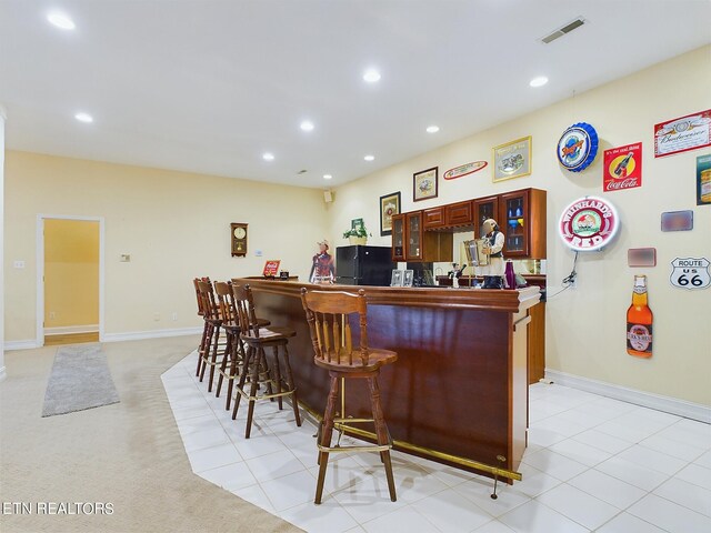 bar with light carpet and black fridge