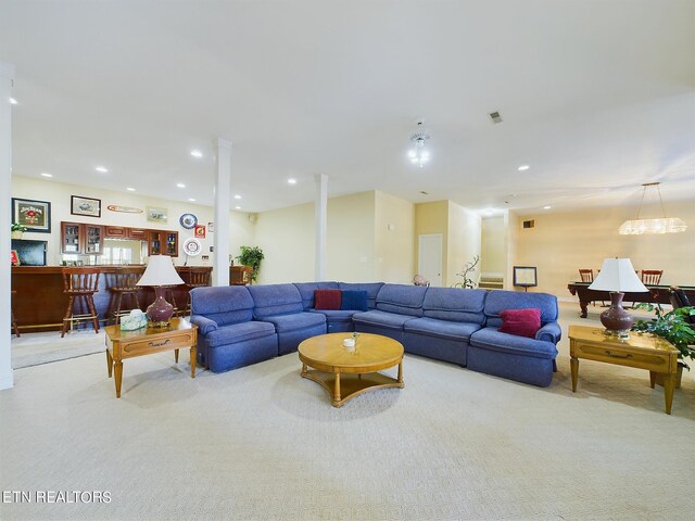 living room featuring light colored carpet and bar area