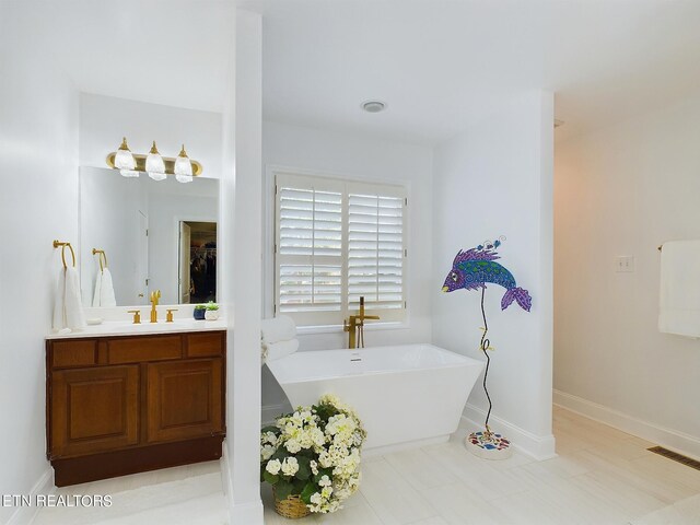 bathroom featuring vanity and a tub