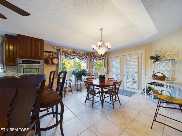 dining space featuring french doors, a healthy amount of sunlight, and light tile patterned floors