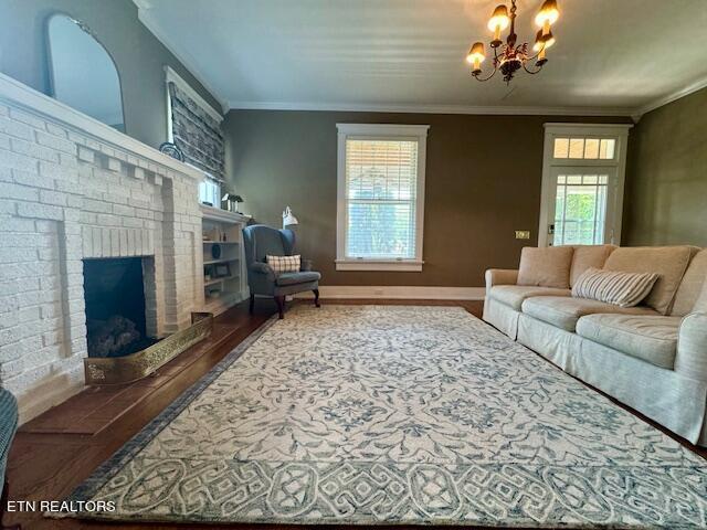 living room featuring a wealth of natural light, ornamental molding, and a brick fireplace