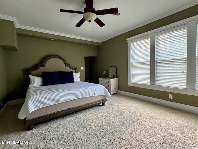 bedroom with carpet, ceiling fan, and ornamental molding