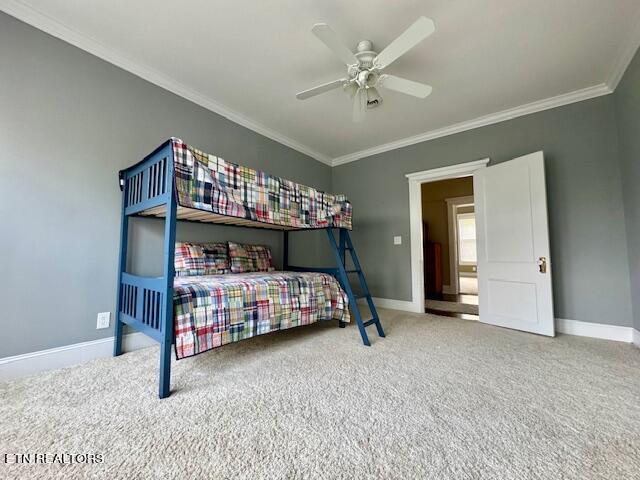 bedroom with ceiling fan, crown molding, and carpet floors