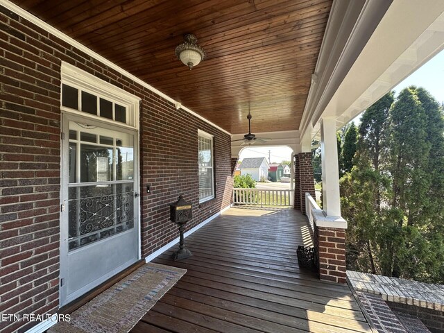 wooden terrace with ceiling fan and a porch