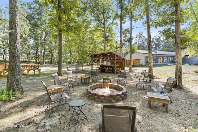 view of patio / terrace with a pergola and a fire pit