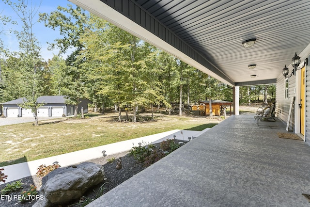 view of patio featuring a garage and an outdoor structure