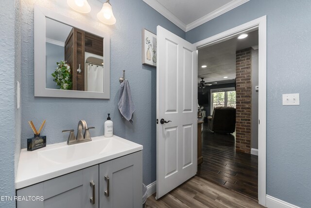 bathroom with ornamental molding, vanity, ceiling fan, hardwood / wood-style flooring, and curtained shower