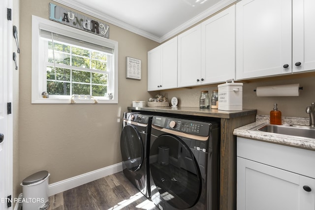 laundry room featuring cabinets, crown molding, sink, separate washer and dryer, and dark hardwood / wood-style floors