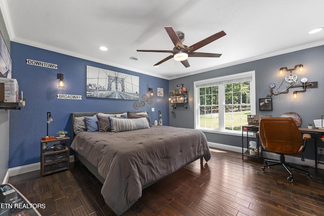 bedroom featuring dark hardwood / wood-style flooring, ceiling fan, and ornamental molding