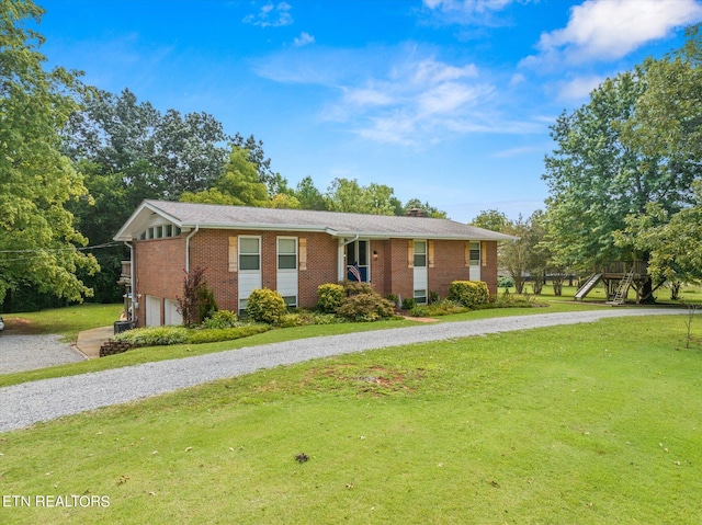 ranch-style house with a garage and a front lawn