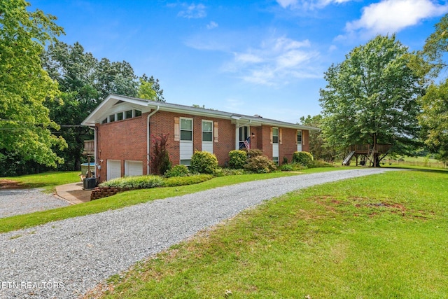 ranch-style home with a garage and a front lawn