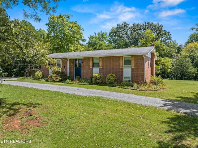 ranch-style house with a porch and a front yard