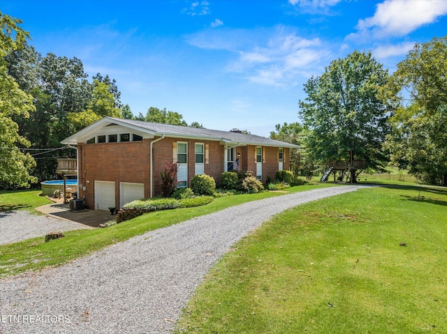 single story home with a garage and a front yard