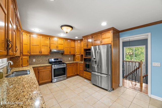 kitchen featuring backsplash, light tile patterned floors, light stone countertops, stainless steel appliances, and sink