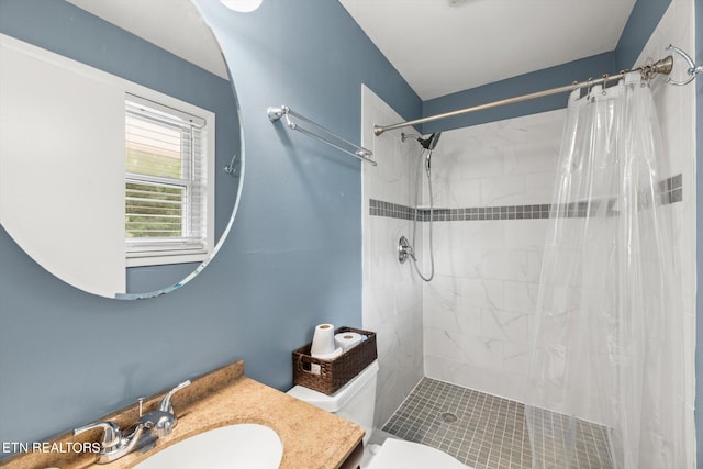 bathroom with vanity, toilet, and walk in shower