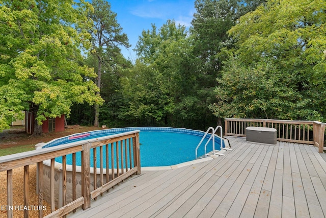 view of swimming pool featuring a wooden deck