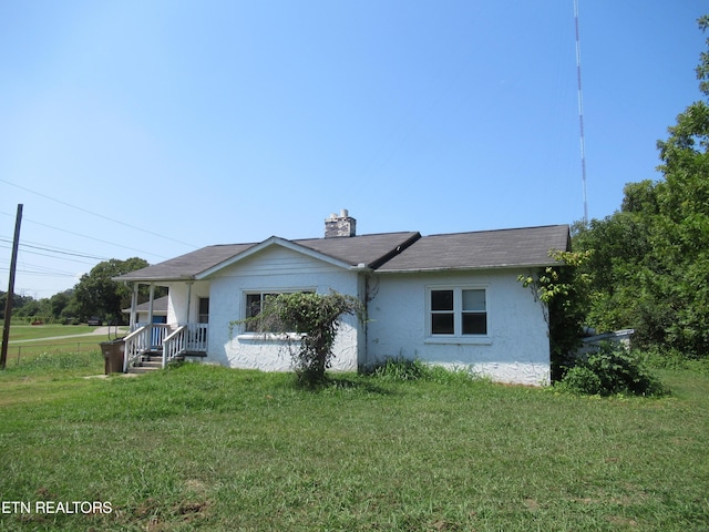 10827 Rutledge Pike, Blaine, TN 37709 - view of front of home with stucco siding, a chimney, and a front lawn